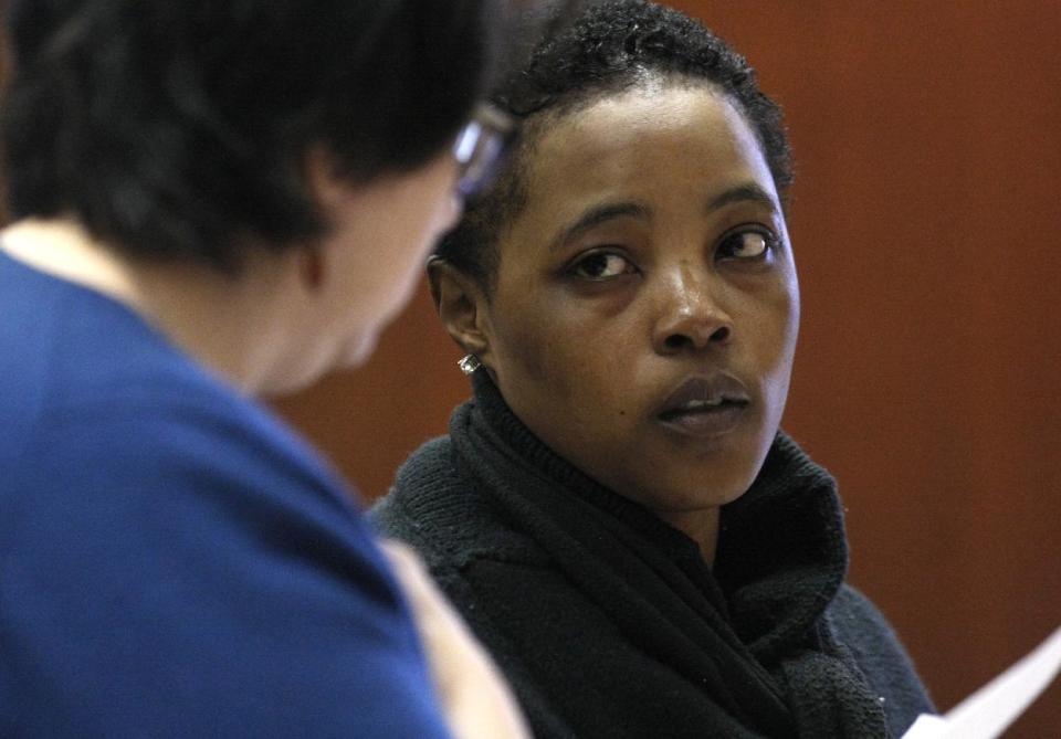 Defense attorney Susan Freedman, left, stands with her client Haniyyah Barnes, Tuesday, April 29, 2014, in Newark, N.J. Barnes admitted killing her neighbor's dog during an argument over a parking space. The Star-Ledger of Newark reports that Barnes pleaded guilty Tuesday to breaking into her neighbor's home, grabbing the 2-year-old Shih Tzu named Honey Bey and throwing the dog into oncoming traffic in August 2011, where she was struck by a vehicle and killed. Barnes will be sentenced July 14. (AP Photo/The Star-Ledger, Patti Sapone)