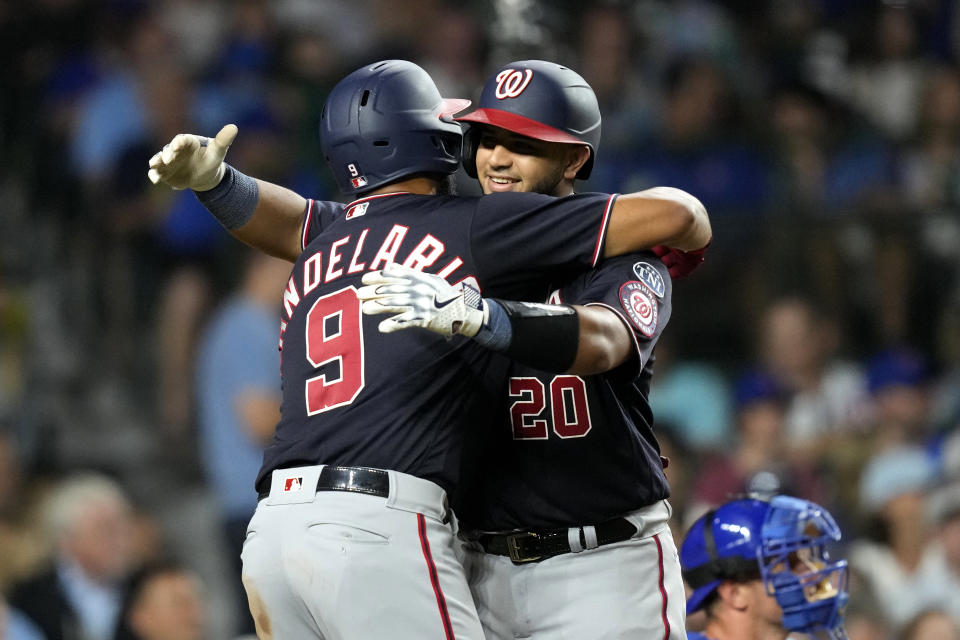 Washington Nationals' Jeimer Candelario (9) greets Keibert Ruiz at home after they scored on Ruiz's two-run home run during the seventh inning of a baseball game against the Chicago Cubs Monday, July 17, 2023, in Chicago. (AP Photo/Charles Rex Arbogast)