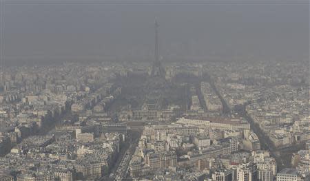 A general view shows the Eiffel tower and the Paris skyline through a small-particle haze March 13, 2014 as warm and sunny weather continues in France. REUTERS/Philippe Wojazer