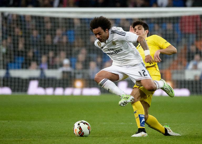 Real Madrid's defender Marcelo (L) vies with Villarreal's defender Jose Antonio Dorado during the Spanish league football match in Madrid on March 1, 2015