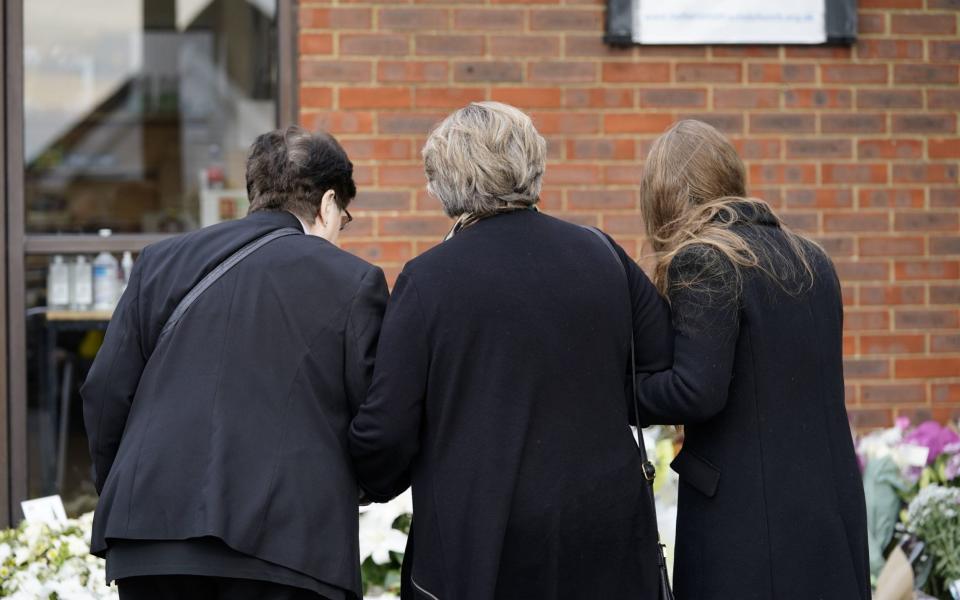 Lady Amess (centre) stands alongside family members as she surveys the tribute - Aaron Chown/PA Wire