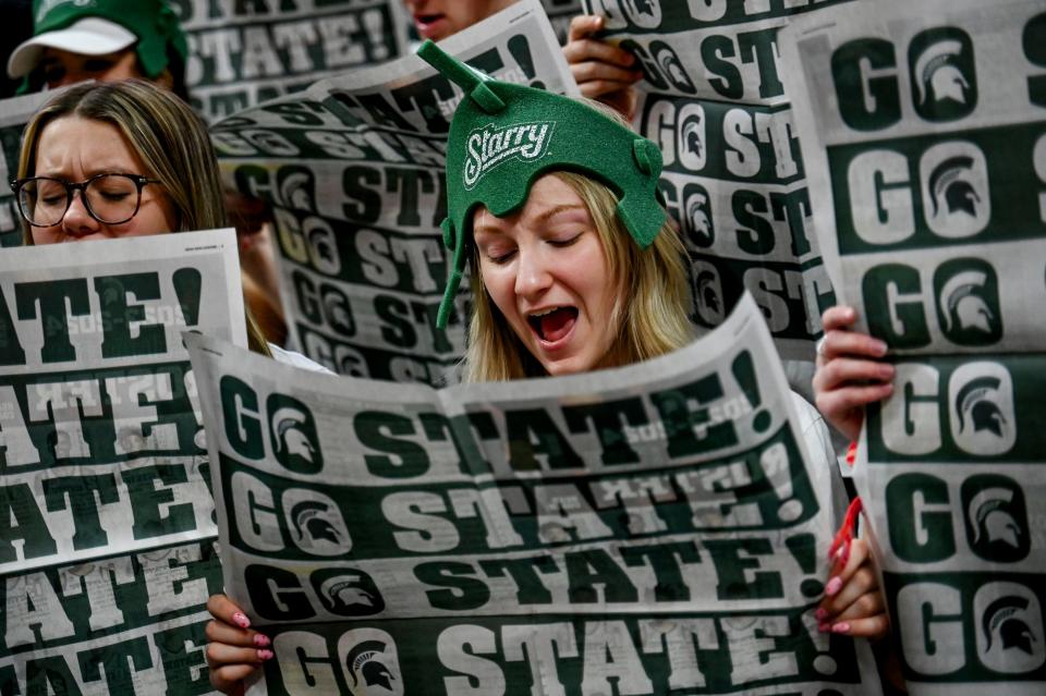 Izzone student section leader Kristina Drabczyk reads a newspaper to ignore the Maryland player introductions before MSU's basketball game against the Terrapins on Saturday, Feb. 3, 2024, at the Breslin Center in East Lansing.