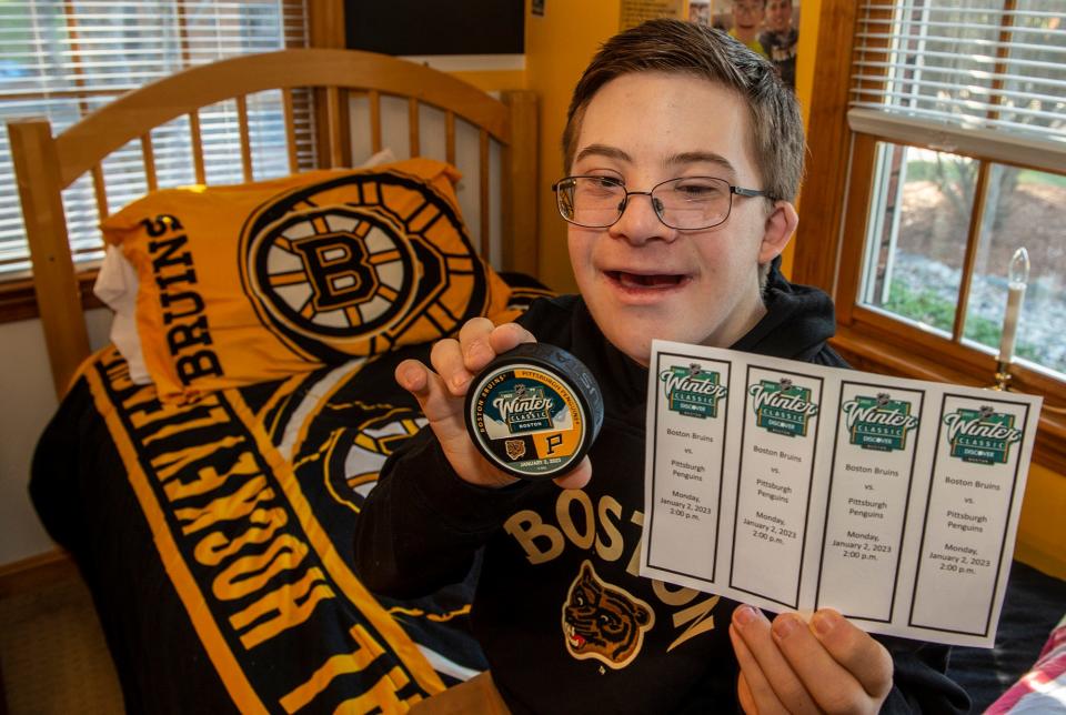 Liam Fitzgerald, 15, of Northborough, pictured in his bedroom Dec. 29, 2022. He will fist bump Bruins players at the Winter Classic at Fenway Park, Jan. 2, 2023.