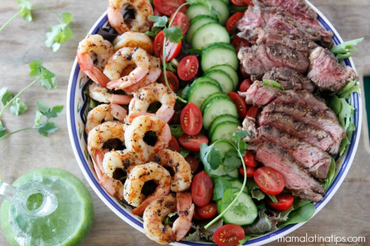 <p>This grilled surf and turf salad combines two favorites: Angus beef steak and shrimp, served on top of colorful and crunchy greens. Finish with a creamy cilantro dressing and enjoy! <strong>Get the Recipe: <a href="https://www.mamalatinatips.com/2018/06/grilled-surf-and-turf-salad-with-cilantro-dressing.html" rel="nofollow noopener" target="_blank" data-ylk="slk:Surf and Turf Salad;elm:context_link;itc:0;sec:content-canvas" class="link rapid-noclick-resp">Surf and Turf Salad</a></strong></p>