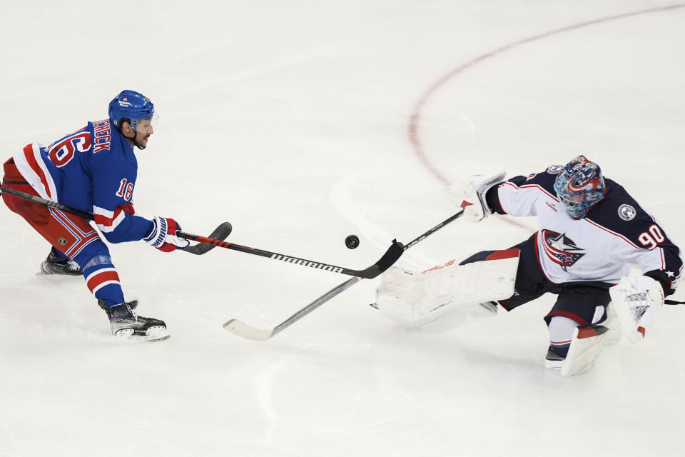 Columbus Blue Jackets goaltender Elvis Merzlikins (90) breaks up a shot by New York Rangers' Vincent Trocheck (16) during the third period of an NHL hockey game Wednesday, Feb. 28, 2024, in New York. (AP Photo/Frank Franklin II)