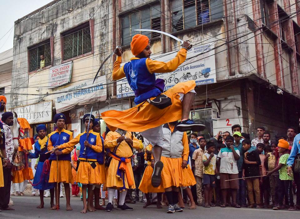 Sikh devotees perform martial arts ‘Gatka’ as they participate in ‘Nagar Kirtan’ (holy procession), ahead of the birth anniversary of Guru Gobind Singh ji, near Central Gurudwara Sahib Gowliguda, in Hyderabad, on Monday, 18 January 2021.