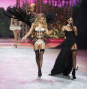 Singer Rihanna (R) sings while a model presents a creation during the Victoria's Secret Fashion Show in New York November 7, 2012. REUTERS/Carlo Allegri (UNITED STATES - Tags: ENTERTAINMENT FASHION SOCIETY)