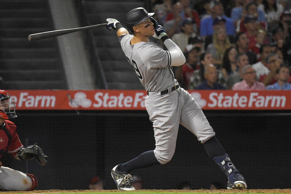 FILE - New York Yankees' Aaron Judge hits a solo home run, his 50th home run of the season, as Los Angeles Angels catcher Matt Thaiss looks on, obscured at left, during the eighth inning of a baseball game Monday, Aug. 29, 2022, in Anaheim, Calif. If Aaron Judge passes Roger Maris, some lucky fan might become this generation's Sal Durante. As a 19-year-old in 1961, Durante caught Maris' record-breaking 61st home run. (AP Photo/Mark J. Terrill, File)