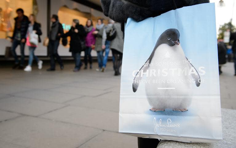 A carrier bag featuring "Monty the Penguin" is shown outside the John Lewis department store in London on November 24, 2014