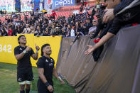 New Zealand's Richie Mo'unga and teammate Tupou Vaa'i, left, react with the crowd following the rugby international between the All Blacks and the USA Eagles at FedEx Field in Landover, Md., Saturday, Oct. 23, 2021. (AP Photo/Alex Brandon)