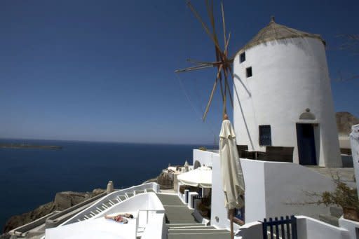 Tourists sunbath on the island of Santorini in 2008