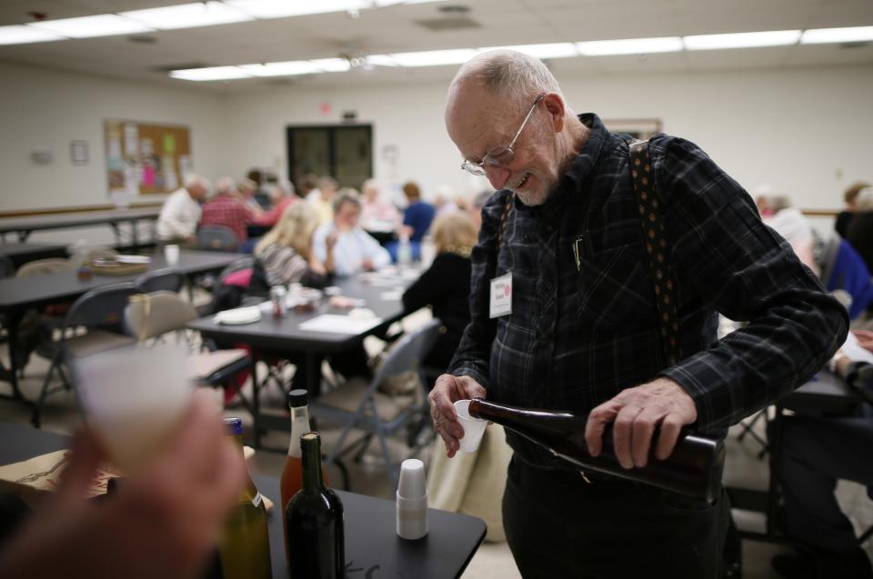 Whitey Sauer, 84, shares out his homemade wine at a singles club in Sun City, Arizona, January 4, 2013. Sun City was built in 1959 by entrepreneur Del Webb as America’s first active retirement community for the over-55's. Del Webb predicted that retirees would flock to a community where they were given more than just a house with a rocking chair in which to sit and wait to die. Today’s residents keep their minds and bodies active by socializing at over 120 clubs with activities such as square dancing, ceramics, roller skating, computers, cheerleading, racquetball and yoga. There are 38,500 residents in the community with an average age 72.4 years. Picture taken January 4, 2013.    REUTERS/Lucy Nicholson (UNITED STATES - Tags: SOCIETY)  ATTENTION EDITORS - PICTURE 7 OF 30 FOR PACKAGE 'THE SPORTY SENIORS OF SUN CITY' SEARCH 'SUN CITY' FOR ALL IMAGES