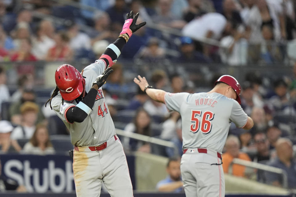 Cincinnati Reds' Elly De La Cruz, left, celebrates with third base coach J.R. House, right, as he runs the bases after hitting a two-run home run during the fifth inning of a baseball gameagainst the New York Yankees, Tuesday, July 2, 2024, in New York. (AP Photo/Frank Franklin II)