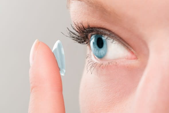 Woman inserting a contact lens - Getty Images