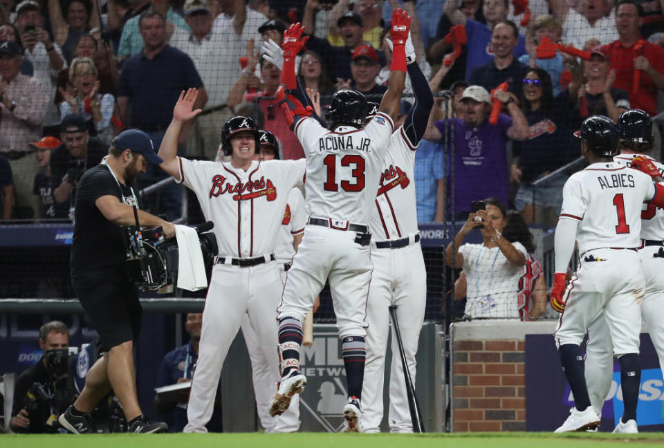 Ronald Acuna Jr. celebrates with the Braves after a grand slam. (Getty)