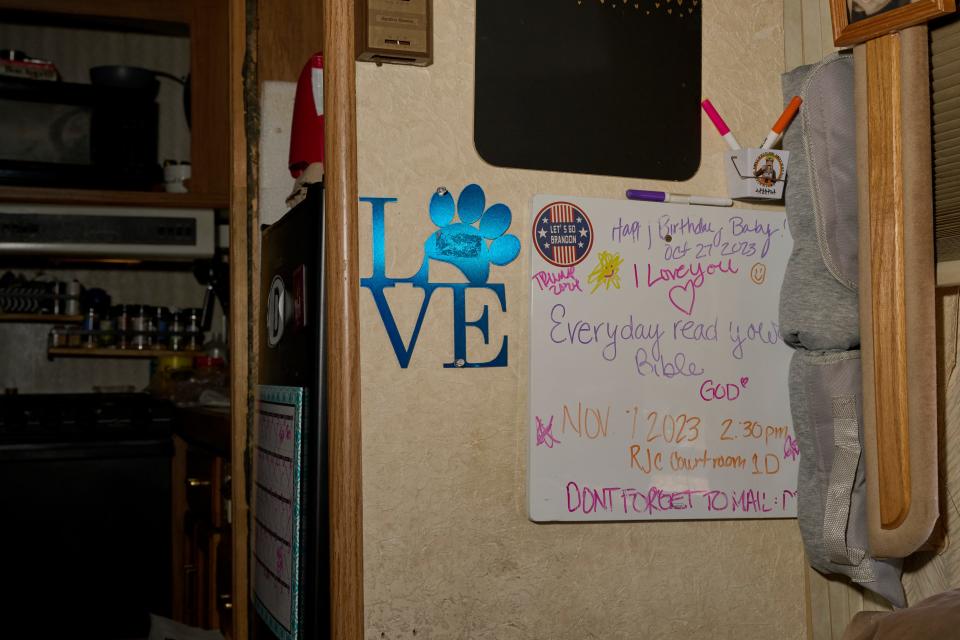 Inside of a trailer, a white-erase board that hangs on the wall, displays encouraging messages.