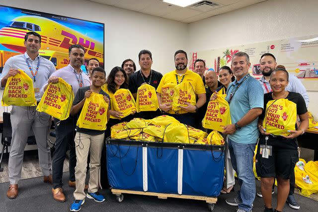 <p>DHL</p> DHL staffers participate in a 2023 Fill a Backpack drive.