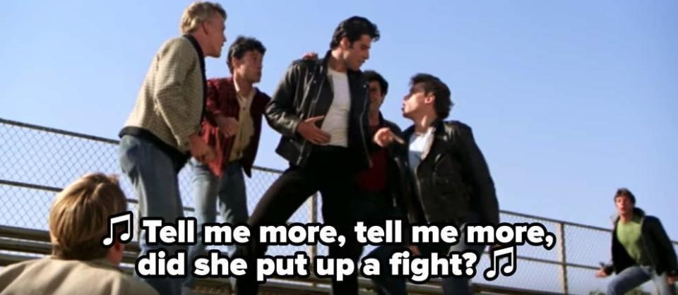 Still from Grease of one of the T-Birds singing "Tell me more, tell me more, did she put up a fight?"