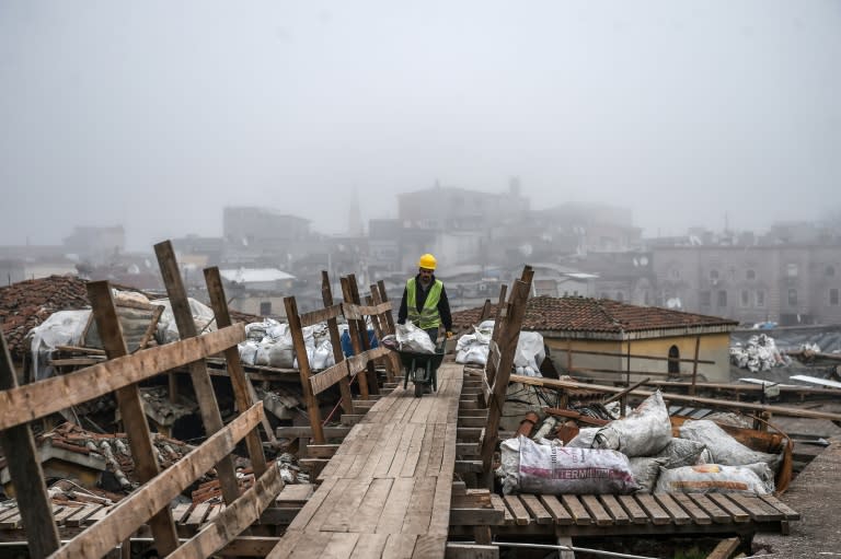 A worker pushes a wheelbarrow on the top of Istanbul's historic market, the Grand Bazaar