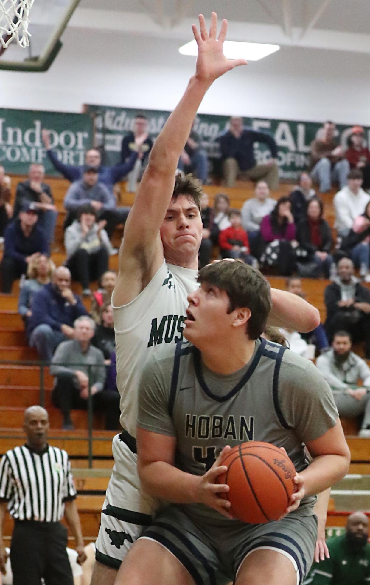 Strongsville's Cal Klinzing defends as Archbishop Hoban's Sam Greer looks to shoot in the OHSAA Division I District semifinal game at Elyria Catholic High School on Thursday March 7, 2024. Hoban defeated Strongsville 55 to 54.
