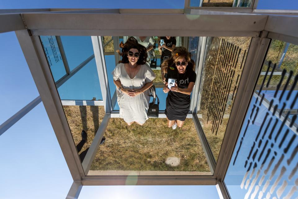 Jaime Thompson, left, and Dana Tacker, right, walk around and through Eva Schlegel’s art installation "Multiple Voices" on Aug. 31 at Campbell Art Park near Oklahoma Contemporary in Oklahoma City.