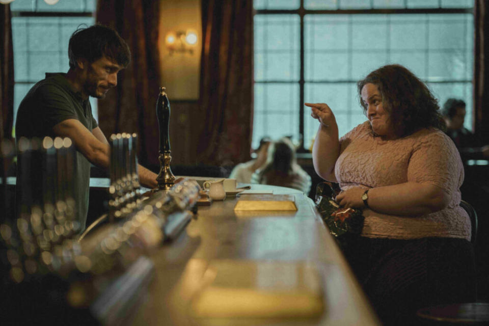 A still from the Netflix show Baby Reindeer featuring the actors Richard Gadd and Jessica Gunning during a scene in a pub