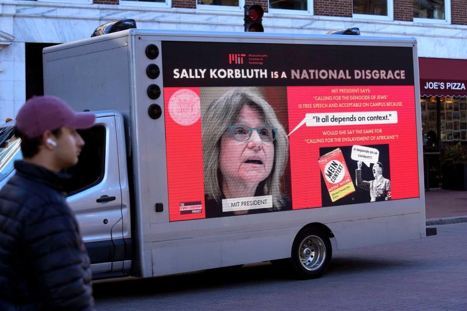 A truck with electronic panels drives along a street on 12 December near Harvard University, in Cambridge, Mass, while displaying messages calling attention to a recent controversy involving testimony to Congress by presidents of three prestigious schools, including Harvard University, MIT, and the University of Pennsylvania (AP)