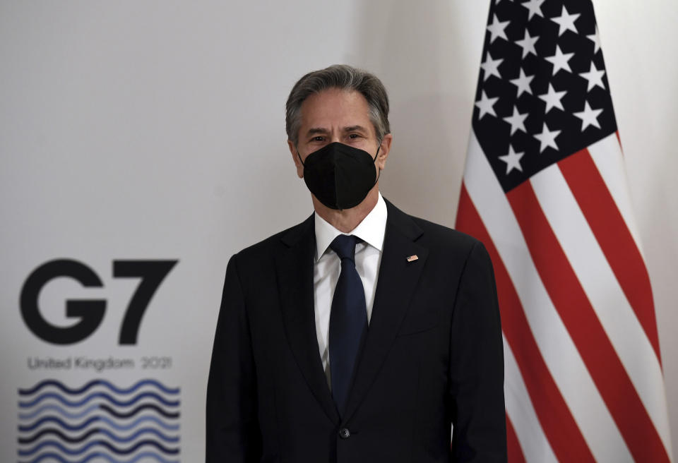 US Secretary of State Antony Blinken, wearing face coverings to combat the spread of the coronavirus, poses for a photograph with Britain's Foreign Secretary Liz Truss before a bilateral meeting ahead of the G7 foreign ministers summit in Liverpool, England, Friday, Dec. 10, 2021. Blinken arrived in Britain for a G7 ministers' meeting before visiting Indonesia, Malaysia and Thailand. (Olivier Douliery/Pool Photo via AP)