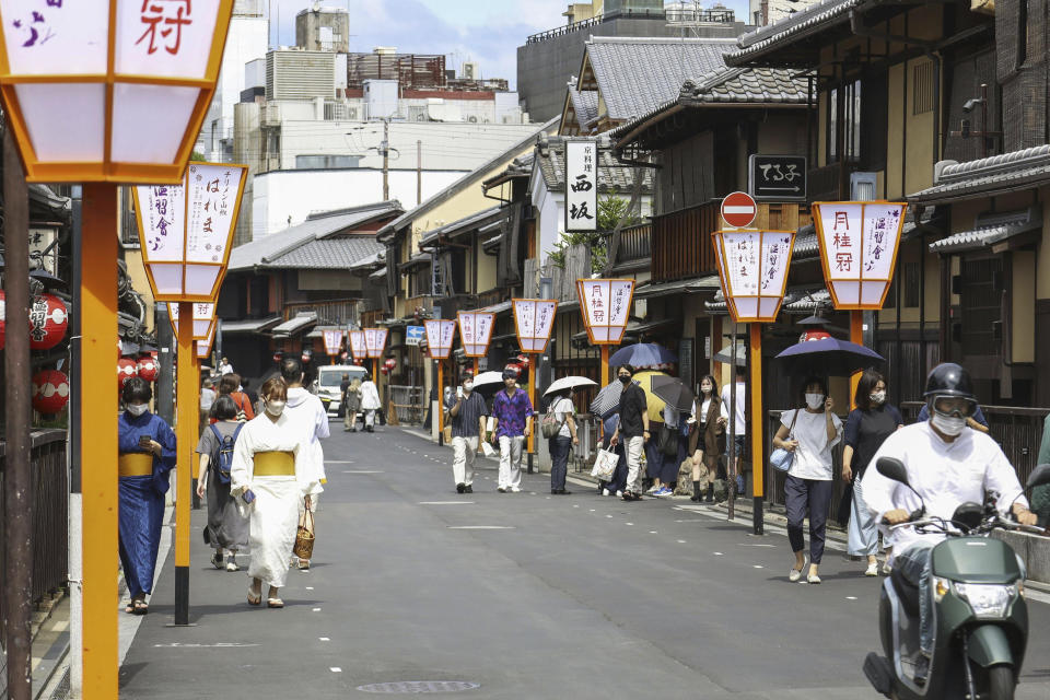 People walk along a street in Gion area, Kyoto, western Japan on Sept. 7, 2022. 