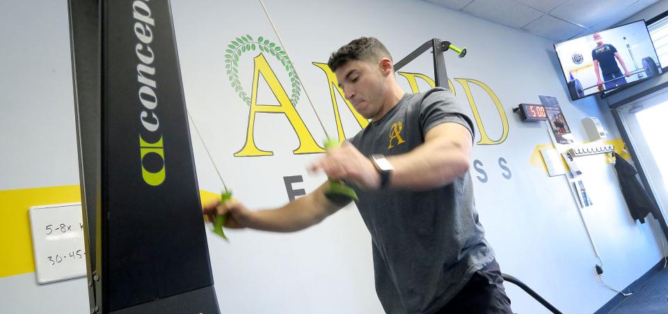 AMP'D Fitness owner Max Gomez demonstrates one of the machines in the Brielle fitness studio Monday, December 5, 2022.  The nearly two-year-old gym with locations in Manasquan and Brielle specializes in personalized strength training for adults ages 30 and over.