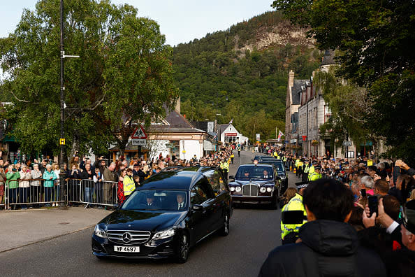 <div class="inline-image__caption"><p>People gather in tribute as the cortege carrying the coffin of the late Queen Elizabeth II passes by on September 11, 2022 in Ballater, United Kingdom. </p></div> <div class="inline-image__credit">Jeff J Mitchell/Getty Images</div>