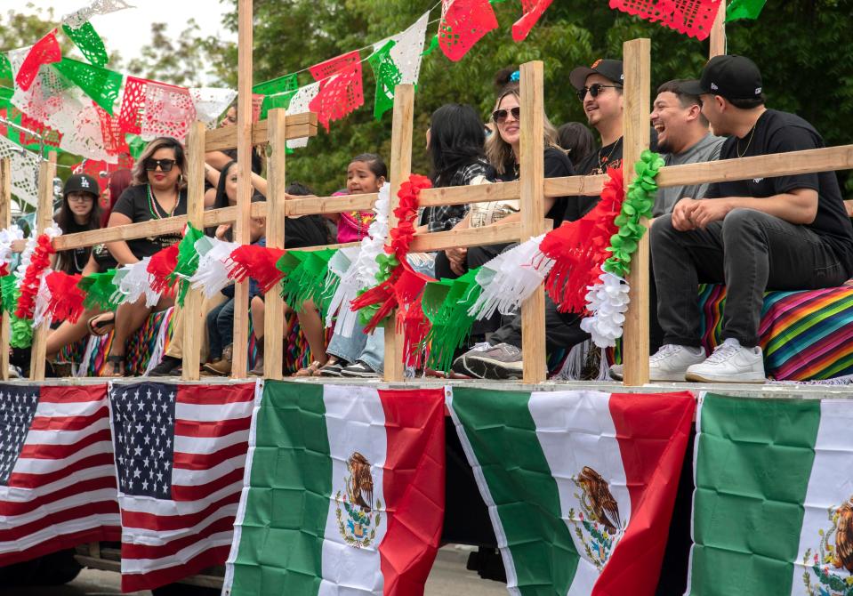 People ride the Sangre Car and Bike Lowrider Club float in El Concilio's annual Cinco de Mayo parade and festival in downtown Stockton on Sunday, May, 7, 2023.