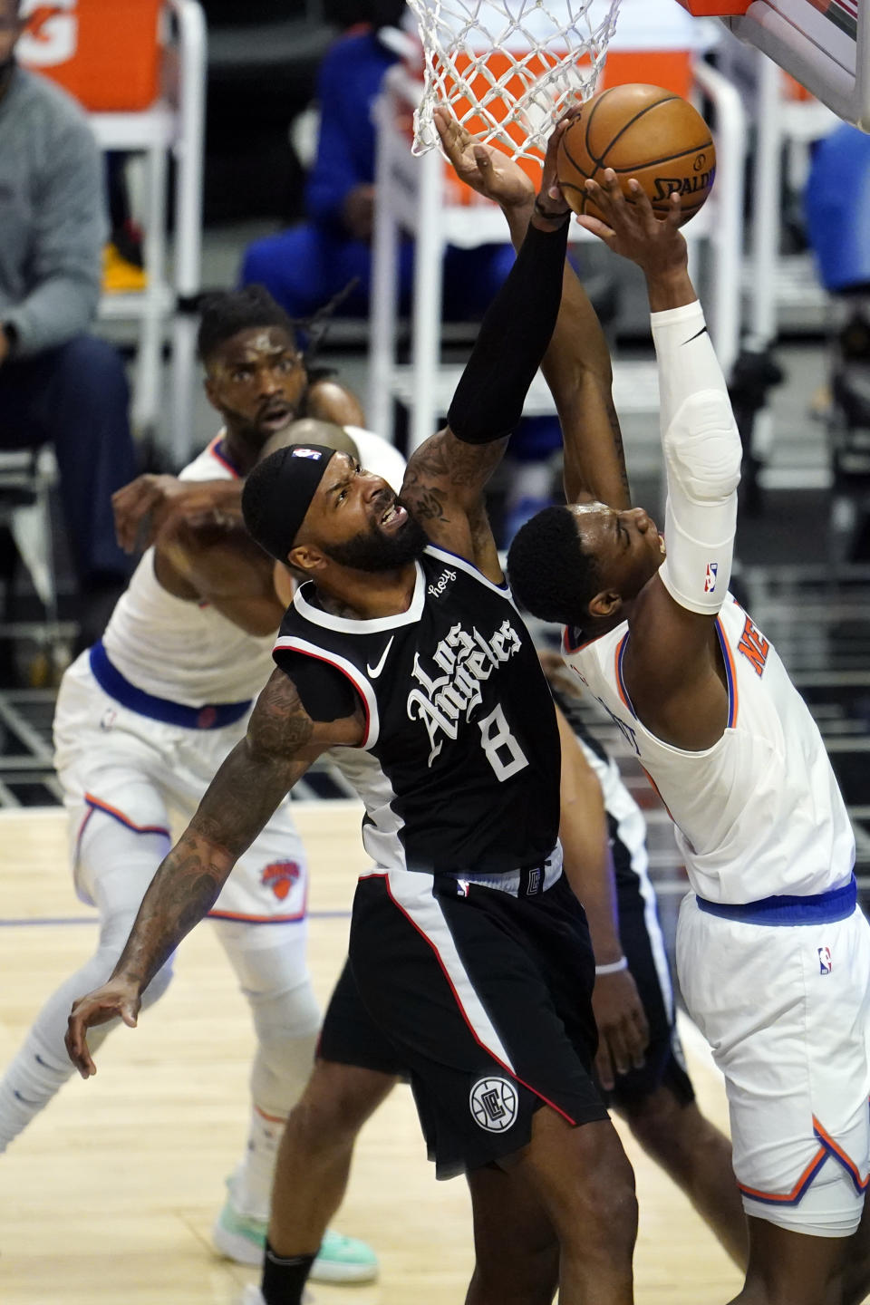 Los Angeles Clippers forward Marcus Morris Sr., left, blocks a shot from New York Knicks guard RJ Barrett during the first half of an NBA basketball game Sunday, May 9, 2021, in Los Angeles. (AP Photo/Marcio Jose Sanchez)