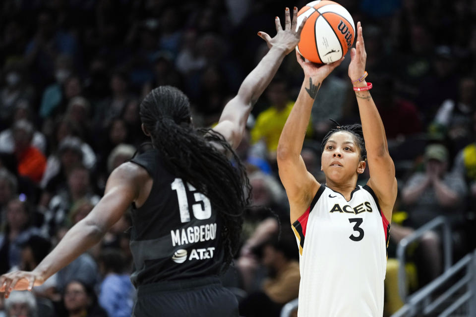 FILE - Las Vegas Aces forward Candace Parker (3) looks to shoot against Seattle Storm center Ezi Magbegor (13) during the second half of a WNBA basketball game Saturday, May 20, 2023, in Seattle. Parker plans on playing another season if she's healthy enough to do so. The two-time WNBA MVP missed the Las Vegas Aces run to a second straight league championship after having surgery on her left foot in late July. (AP Photo/Lindsey Wasson, File)