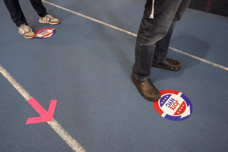 Voters stand six feet apart while waiting to car their ballot during early voting at the Park Slope Armory YMCA, Tuesday, Oct. 27, 2020, in the Brooklyn borough of New York. (AP Photo/Mary Altaffer)