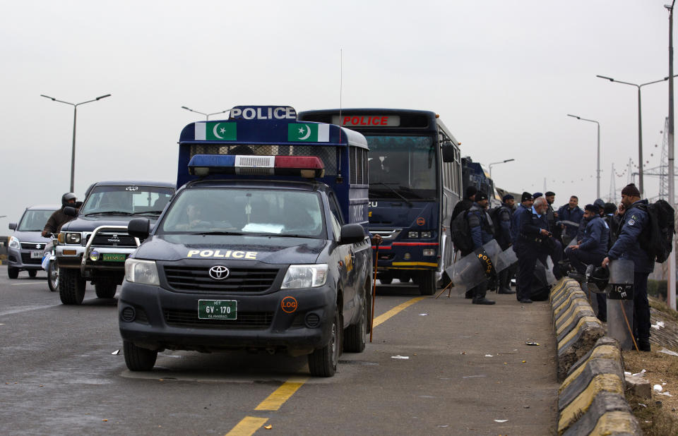 Pakistani police officers stand alert to stop protesters from entering the capital following the Supreme Court's decision to uphold the acquittal of Aasia Bibi, in Islamabad, Pakistan, Wednesday, Jan. 30, 2019. A radical Islamic party of Pakistan has asked its followers to hold nationwide protests Friday against the Supreme Court's recent decision of acquitting Bibi, a Christian woman, who spent eight precious years of her life on death row after being convicted in a controversial blasphemy case. (AP Photo/B.K. Bangash)
