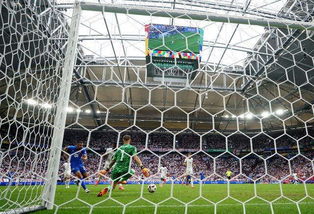 Slovakia’s Ivan Schranz (left) scores the first goal of the game against England 