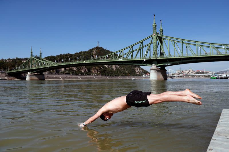 Participants swim across the Danube River during the Budapest Urban Games in Budapest