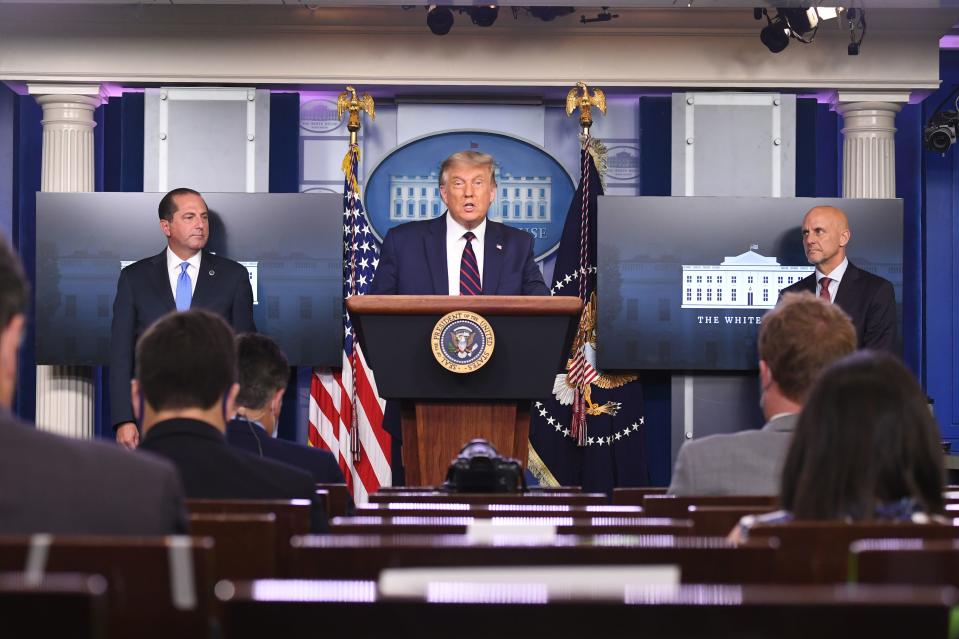 US President Donald Trump speaks alongside FDA Commissioner Stephen Hahn (R) and Health and Human Services Secretary Alex Azar during a press conference in the Press Briefing Room of the White House in Washington, DC, August 23, 2020. - American authorities announced an emergency approval of blood plasma from recovered coronavirus patients as a treatment against the disease that has killed over 176,000 in the US. (Photo by SAUL LOEB / AFP) (Photo by SAUL LOEB/AFP via Getty Images)