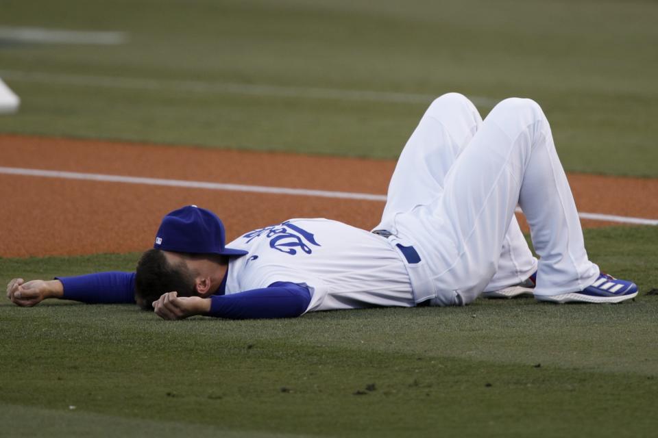 Dodgers shortstop Corey Seager lays on the field before game four.