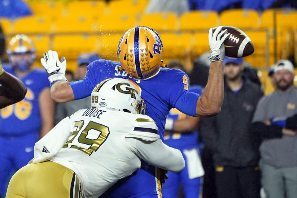 Georgia Tech defensive lineman D'Quan Douse (99) hits Pittsburgh quarterback Kedon Slovis (9) as he tries to pass during the first half of an NCAA college football game, Saturday, Oct. 1, 2022, in Pittsburgh. The pass fell incomplete. (AP Photo/Keith Srakocic)