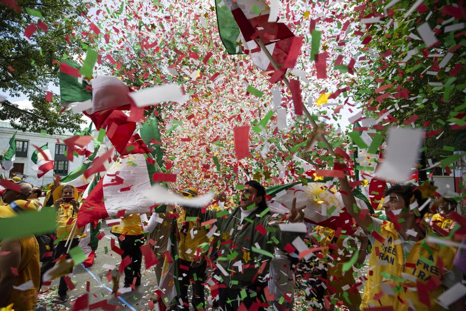 Confetti fills the air as activists gather at the State Department before a march to the White House to call for regime change in Iran, Friday, June 21, 2019, in Washington. (AP Photo/Alex Brandon)