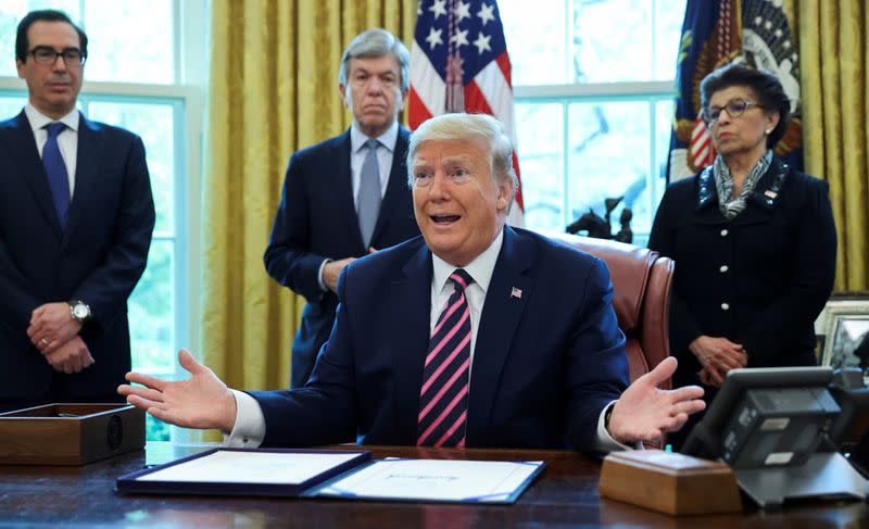 FILE PHOTO: U.S. President Trump participates in coronavirus relief bill signing ceremony at the White House in Washington