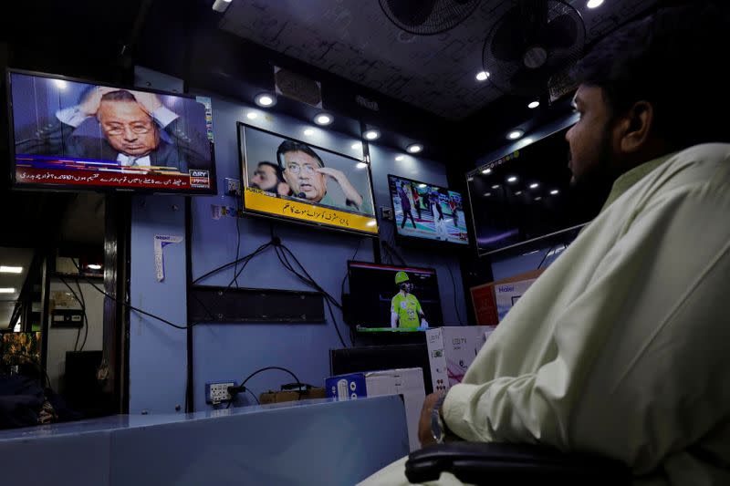 A shopkeeper observes screens displaying the news after Pakistani court sentenced former military ruler Pervez Musharraf to death on charges of high treason and subverting the constitution, at a shop in Karachi