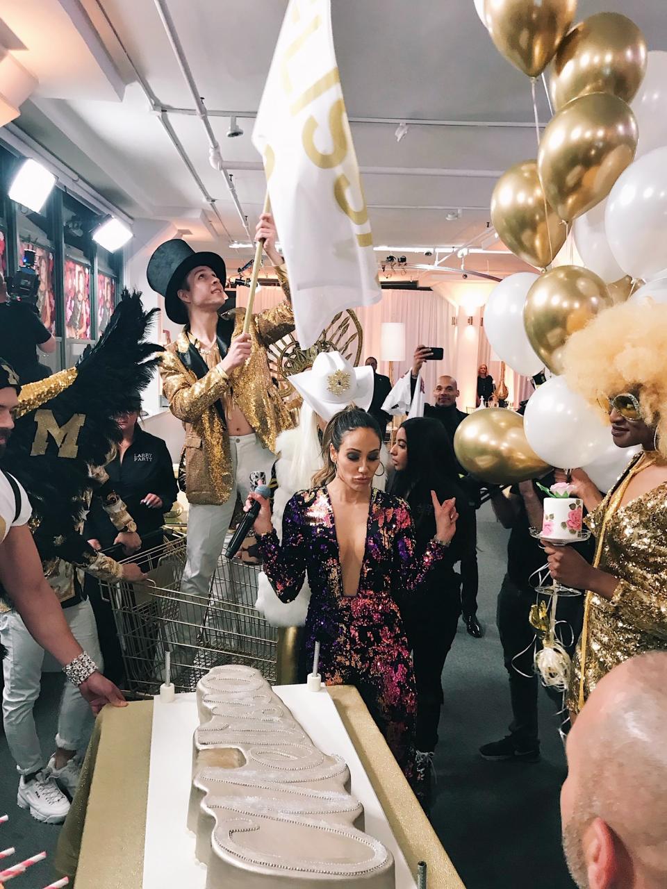 The cake was presented to Gorga by a parade of servers, all dressed in gold and white glittery outfits. They carried balloons, sparklers and even more treats. One rode standing in a shopping cart, waving a flag that read "Melissa's 40." 