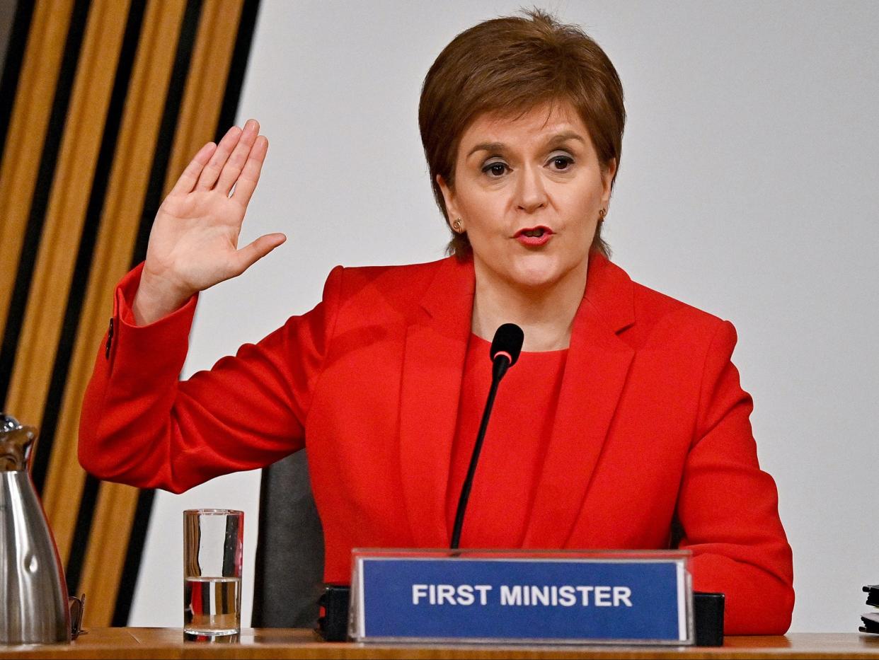 Nicola Sturgeon taking oath before giving evidence to the committee (PA)