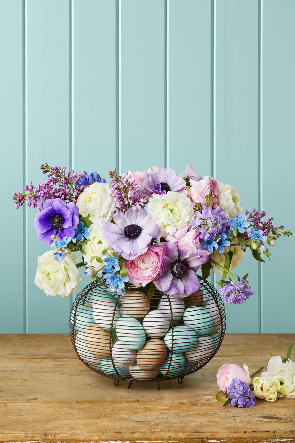 <p>A vintage French egg collecting basket filled with colorful wooden eggs makes the perfect home for displaying your abundant spring bouquet (here are lilacs, anemones, Scabiosa lavender, allium, and ranunculus).</p><p><strong>To make:</strong> Dye or paint wooden eggs white or robin's egg blue. You can also leave a few natural. Place a vase inside the basket and surround with eggs. Fill vase with water and flowers. </p><p><a class="link " href="https://www.amazon.com/Unfinished-Unpainted-Wooden-Easter-Decorate/dp/B083GG6VQ9/ref=sr_1_7?tag=syn-yahoo-20&ascsubtag=%5Bartid%7C10050.g.1111%5Bsrc%7Cyahoo-us" rel="nofollow noopener" target="_blank" data-ylk="slk:SHOP WOODEN EGGS;elm:context_link;itc:0;sec:content-canvas">SHOP WOODEN EGGS</a></p>