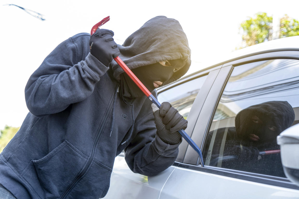 File image of car thief trying to break into a vehicle posed by model. (Getty Images)