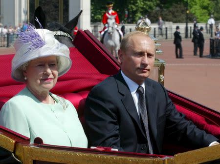 Britain's Queen Elizabeth II and Russian President Vladimir Putin ride in a carriage to Buckingham Palace in London, Britain, in this June 24, 2003 file photo. REUTERS/Grigory Dukor/Files