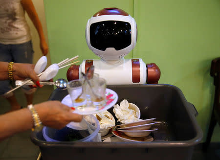 A robot collects dishes to be cleaned at Chilli Padi Nonya Cafe in Singapore July 6, 2016. Picture taken July 6, 2016. REUTERS/Edgar Su